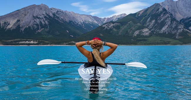 Woman in kayak in mountain lake